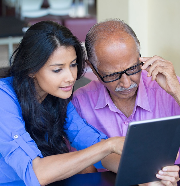 Woman and man reading an ipad.
